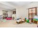 Spacious living room featuring neutral walls, carpet and plenty of natural light at 12822 Plumleaf Dr, Charlotte, NC 28213