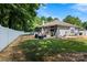 Large backyard with a white fence, green grass, patio area and lots of mature trees, providing shade at 13517 Silver King Ct, Huntersville, NC 28078