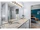 Bathroom featuring double sinks with granite countertops and modern lighting fixtures at 13517 Silver King Ct, Huntersville, NC 28078