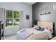 Stylish bedroom showcasing a comfortable bed, grey walls and lots of natural light from the large window at 13517 Silver King Ct, Huntersville, NC 28078