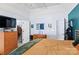 Spacious bedroom with hardwood floors, a TV on dresser, and access to walk-in closet at 13517 Silver King Ct, Huntersville, NC 28078