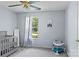 Minimalist Bedroom featuring a crib, baby activity center, and a large window that floods the room with natural light at 13517 Silver King Ct, Huntersville, NC 28078