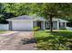 Charming one-story home with a well-manicured lawn and inviting front porch with white columns and attached two car garage at 13517 Silver King Ct, Huntersville, NC 28078