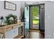 Inviting foyer with wood floors, a console table, and a view to the green front yard at 13517 Silver King Ct, Huntersville, NC 28078