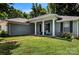 Charming one-story home with a well-manicured lawn and inviting front porch with white columns and black shutters at 13517 Silver King Ct, Huntersville, NC 28078