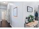 Inviting hallway with dark wood floors and decor that provides a warm and welcoming feeling upon entering the home at 13517 Silver King Ct, Huntersville, NC 28078