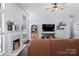 Open living room featuring hardwood floors, a fireplace, a large screen tv, and lots of natural light at 13517 Silver King Ct, Huntersville, NC 28078