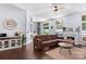 Spacious living room with hardwood floors, a fireplace, a sectional sofa, and plenty of natural light at 13517 Silver King Ct, Huntersville, NC 28078