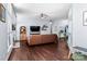 Bright living room featuring hardwood floors, a fireplace, and a comfortable leather sofa at 13517 Silver King Ct, Huntersville, NC 28078