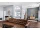 Spacious living room with hardwood floors, neutral paint, and a brown leather sectional sofa at 13517 Silver King Ct, Huntersville, NC 28078