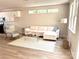 Well-lit living room with an open floor plan featuring modern furniture, large windows, and access to the kitchen at 1683 Interstate View Dr, Gastonia, NC 28052