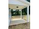 Covered patio perfect for outdoor lounging and entertaining with white pillars and a view of the yard at 1683 Interstate View Dr, Gastonia, NC 28052