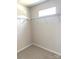 Empty walk-in closet featuring wire shelving, neutral walls, carpet, and a window for natural light at 1683 Interstate View Dr, Gastonia, NC 28052