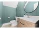 Stylish half bath with modern vanity, elegant mirror, and beautiful wood paneled wall at 17514 Harbor Walk Dr, Cornelius, NC 28031