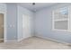Bedroom features neutral carpet, walls and a window for light at 17514 Harbor Walk Dr, Cornelius, NC 28031