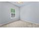 Bedroom with neutral carpet, ceiling fan, and window with bright light at 17514 Harbor Walk Dr, Cornelius, NC 28031