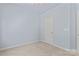 Bedroom with neutral walls, carpet, and a white door at 17514 Harbor Walk Dr, Cornelius, NC 28031