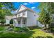 Charming two-story home with a welcoming front porch, manicured lawn, and lush landscaping at 17514 Harbor Walk Dr, Cornelius, NC 28031