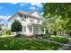 Charming two-story home with a welcoming front porch and lush green lawn at 17514 Harbor Walk Dr, Cornelius, NC 28031