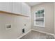 Functional laundry room with cabinets for storage and natural light at 17514 Harbor Walk Dr, Cornelius, NC 28031