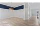 Bright and spacious living room with modern light fixture and white wainscoting at 17514 Harbor Walk Dr, Cornelius, NC 28031