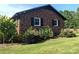 Brick ranch home with black trim, white windows, and landscaping at 3080 Shue Rd, Salisbury, NC 28147