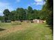 Expansive backyard with mature trees surrounding, providing a sense of privacy and natural beauty at 3080 Shue Rd, Salisbury, NC 28147