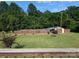 Spacious backyard with large lawn and view of poolhouse nestled amid trees, offering serene privacy at 3080 Shue Rd, Salisbury, NC 28147
