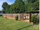 Fenced backyard with grass and landscaping offering a pool view, shrubbery, and an inviting atmosphere at 3080 Shue Rd, Salisbury, NC 28147