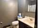 Bathroom featuring gray walls, toilet, vanity with faucet and sink, and shower with curtain at 3080 Shue Rd, Salisbury, NC 28147