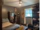 Cozy bedroom featuring a ceiling fan and decoratively adorned shelving and dresser at 3080 Shue Rd, Salisbury, NC 28147