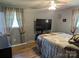 This bedroom boasts neutral tones, natural light, and an accenting patterned bedspread at 3080 Shue Rd, Salisbury, NC 28147