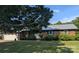 Charming brick home featuring a metal roof, well-manicured lawn, and an attached two-car garage at 3080 Shue Rd, Salisbury, NC 28147