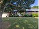 Beautiful brick home with lush lawn, decorative bushes, and a welcoming front porch seating area at 3080 Shue Rd, Salisbury, NC 28147