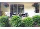 Inviting front porch with hanging flower baskets, seating, and a large grid window at 3080 Shue Rd, Salisbury, NC 28147