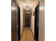 Hallway with wood flooring and doors leading to various rooms and closet at 3080 Shue Rd, Salisbury, NC 28147
