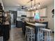 Bright eat-in kitchen with white cabinetry, an island with barstool seating, and updated appliances at 3080 Shue Rd, Salisbury, NC 28147