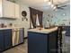 Bright eat-in kitchen with white cabinetry, stainless steel dishwasher, and an island with barstool seating at 3080 Shue Rd, Salisbury, NC 28147
