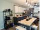 Farmhouse style kitchen featuring a central island, stainless steel refrigerator, and modern shelving at 3080 Shue Rd, Salisbury, NC 28147
