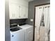Laundry area with washer, dryer, and storage cabinets for organizing supplies at 3080 Shue Rd, Salisbury, NC 28147