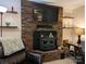 Living room with brick fireplace and mantel and leather chair with blanket at 3080 Shue Rd, Salisbury, NC 28147