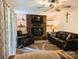 Comfortable living room with a brick fireplace, ceiling fan, leather furniture, and an inviting ambiance at 3080 Shue Rd, Salisbury, NC 28147