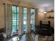 Cozy living room with large windows and comfortable seating area with side table and neutral patterned curtains at 3080 Shue Rd, Salisbury, NC 28147