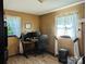 This office features dual windows, a computer setup, and wood laminate flooring at 3080 Shue Rd, Salisbury, NC 28147