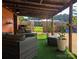 Covered outdoor patio with comfortable seating, potted plants, and view of the landscaped backyard at 3080 Shue Rd, Salisbury, NC 28147