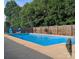 Rectangular pool enclosed by a wooden fence and concrete deck at 3080 Shue Rd, Salisbury, NC 28147
