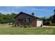 Brick ranch home showing a covered side entrance, a manicured lawn, and an attached garage at 3080 Shue Rd, Salisbury, NC 28147