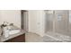 Bathroom featuring double sinks, granite countertops, a tiled shower, and an adjacent linen closet at 4044 Beacon Ave # 152, Monroe, NC 28110
