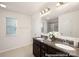 Bathroom featuring double sinks, granite countertops, a tiled shower, and an adjacent linen closet at 4044 Beacon Ave # 152, Monroe, NC 28110