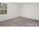 Spacious bedroom with neutral carpet, a large window, and plenty of natural light at 4044 Beacon Ave # 152, Monroe, NC 28110